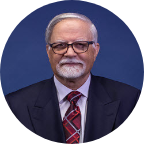 Headshot of Dr. Farhang Mossavar-Rahmani, Professor of Finance and CCL MBA Director. He is wearing a dark suit and a red plaid tie and glasses..