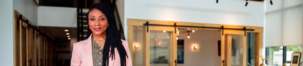 Woman in pink blazer in office