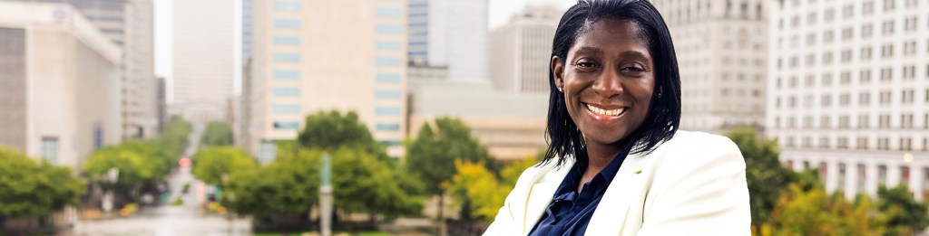 Woman sitting downtown outside office buildings