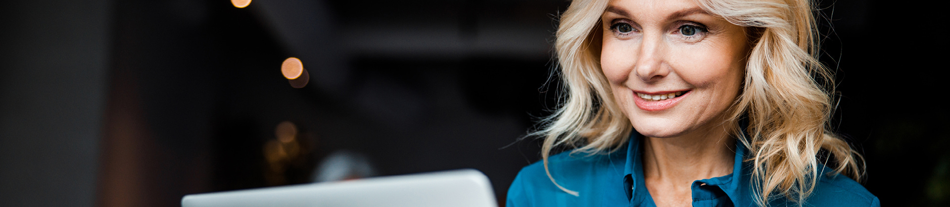 woman smiling at laptop