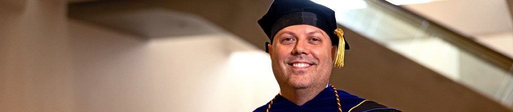 Person wearing commencement cap and gown