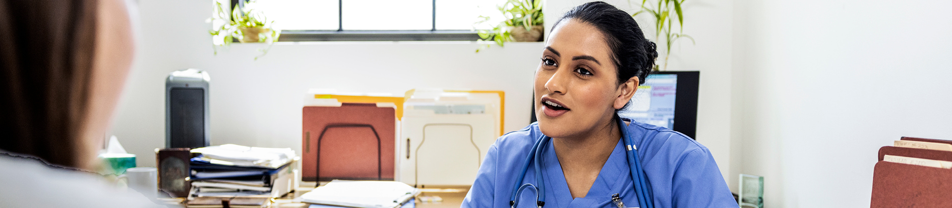 Doctor talking with patient in office