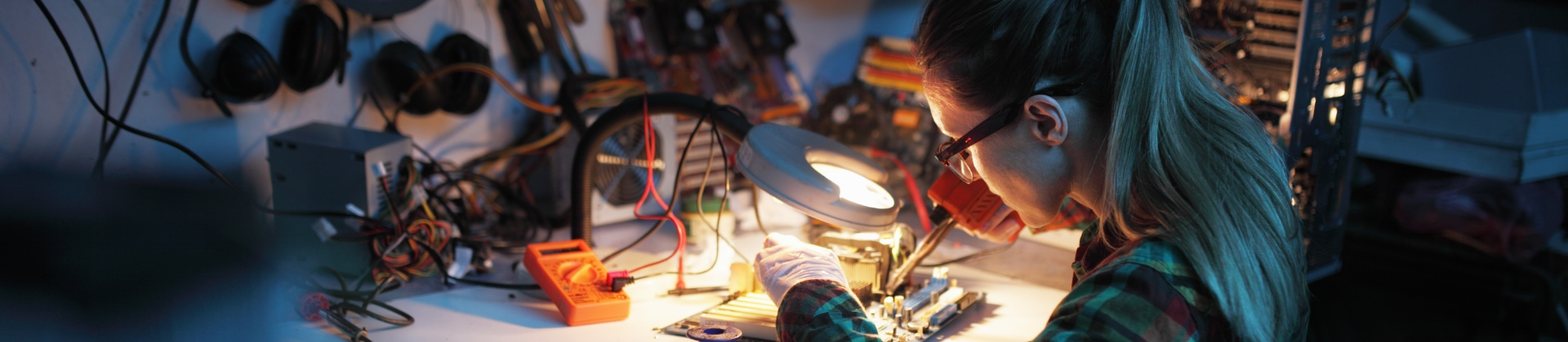 woman works on a circuit board