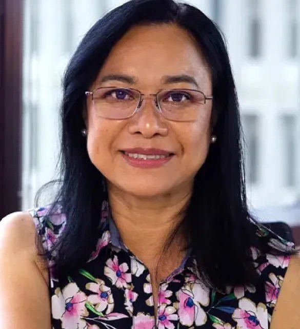 woman smiling at camera at desk