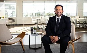 Person wearing a suit sitting in office building