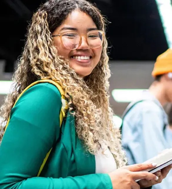woman wearing green jacket in library