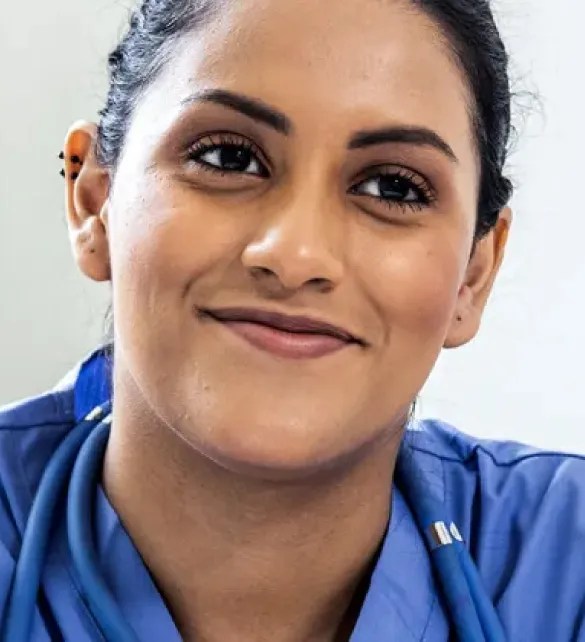 nurse in blue scrubs smiling