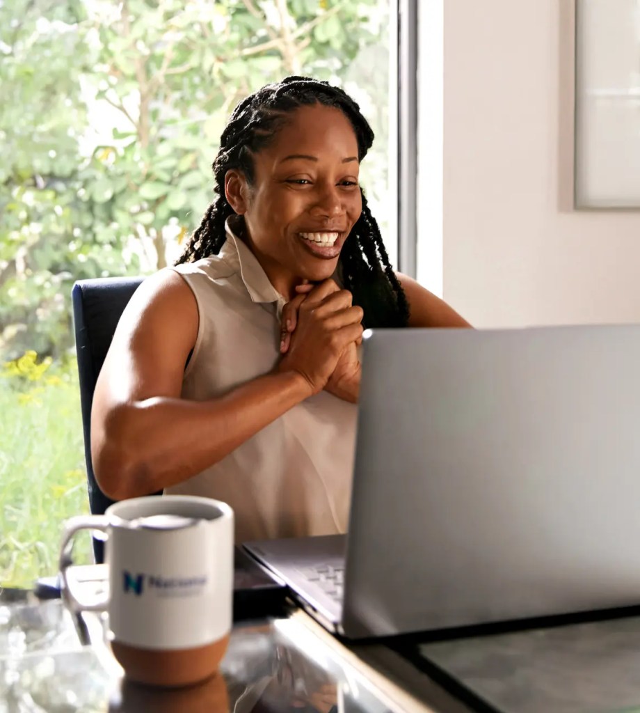 woman clapping hands with National University cup visible