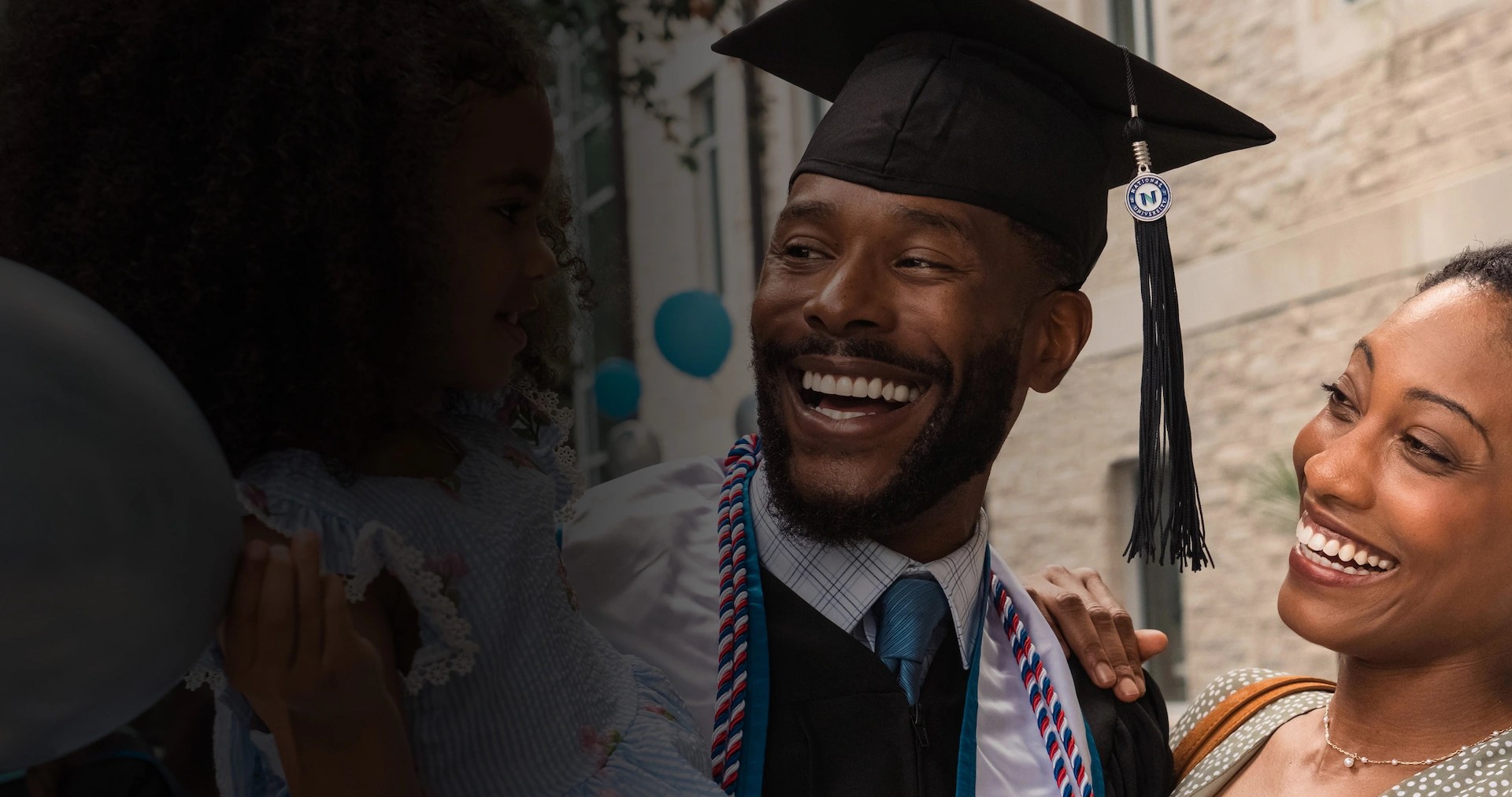 National University homepage photo of graduate student getting degree