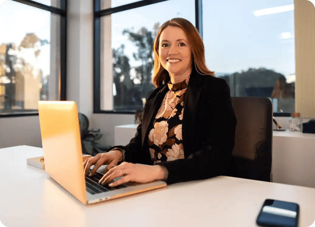 woman working in corner office with windows